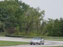 Carlton Bale driving out of Turn 10 at Putnam Park.  1999 Porsche 986 Boxster.  Instructor in the car:  Christine Pugh.  Check out the suspension compression!